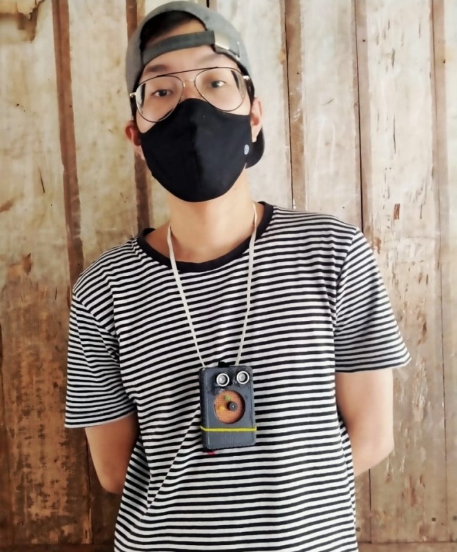 O Jungio with his newly built social distancing warning device.